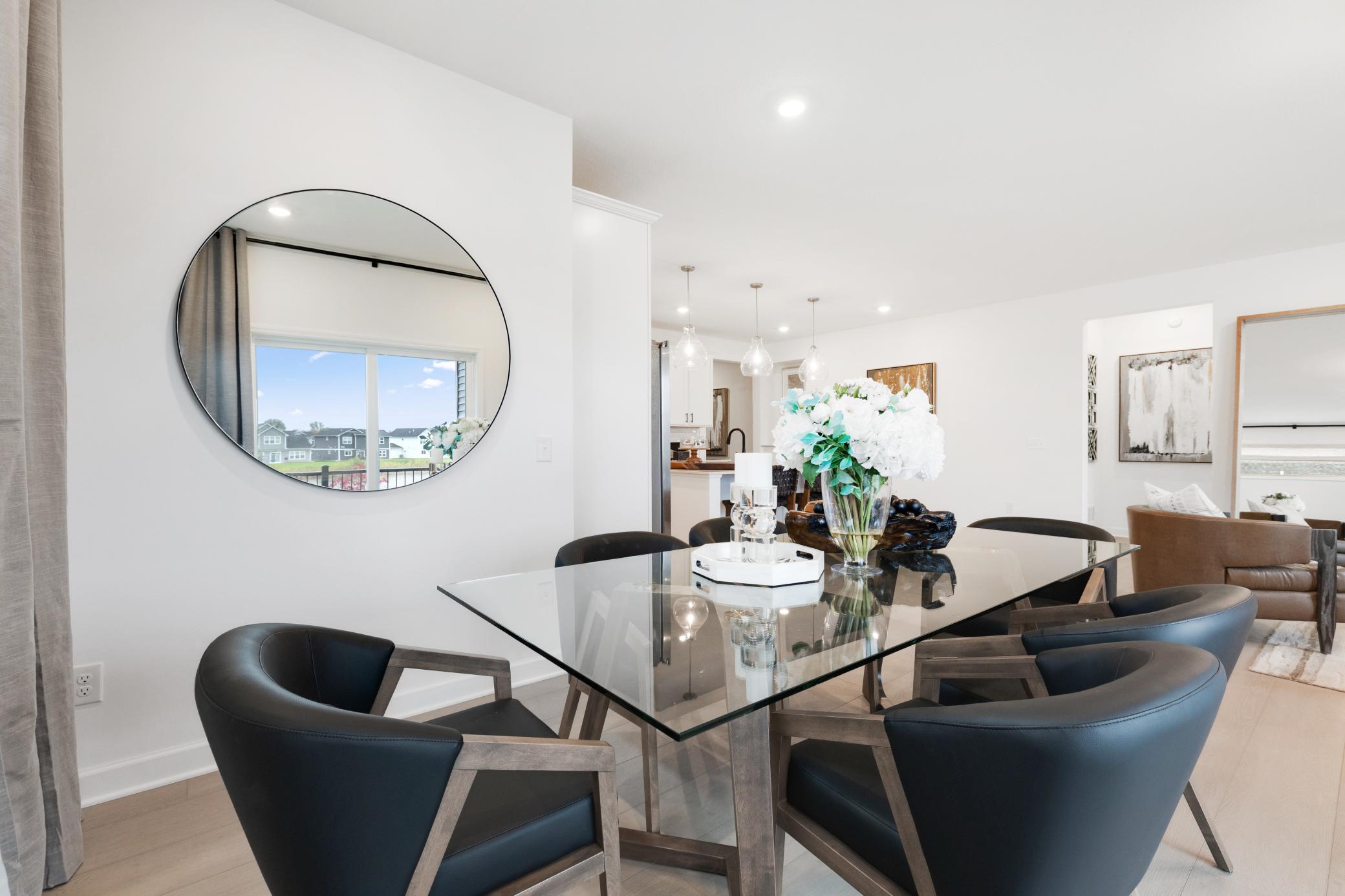 (Photo of a similar home, actual home's finishes will vary slightly) The dining area.