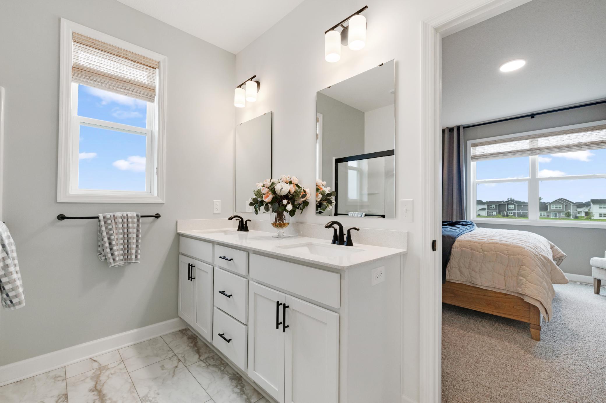 (Photo of a similar home, actual home's finishes will vary slightly) Another view of the primary bath.