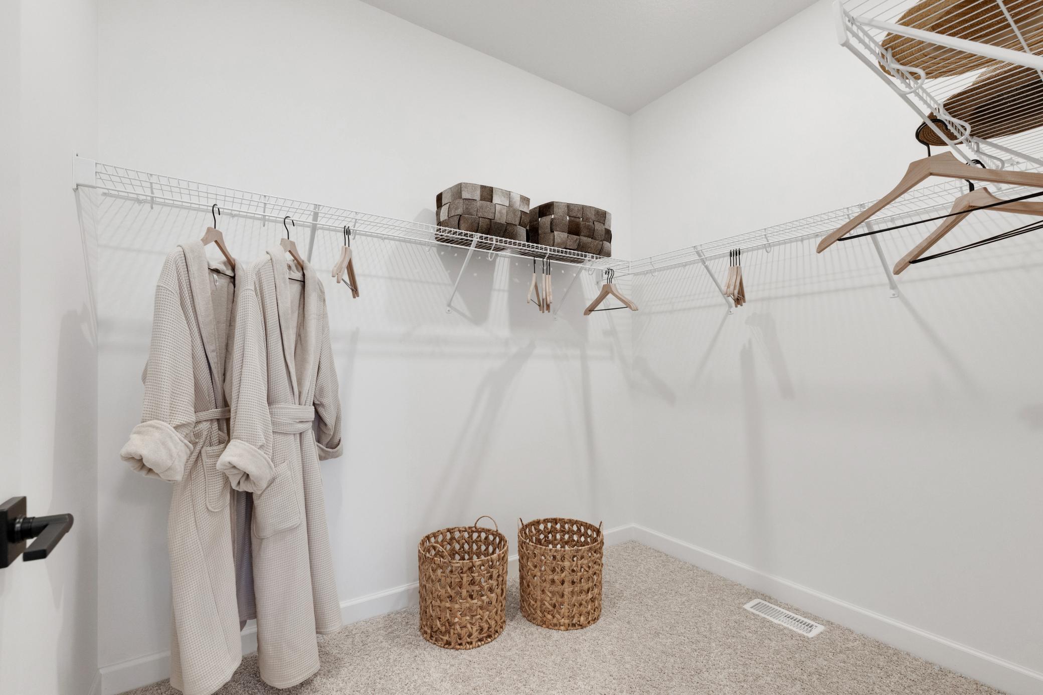 (Photo of a similar home, actual home's finishes will vary slightly) Primary walk-in closet.