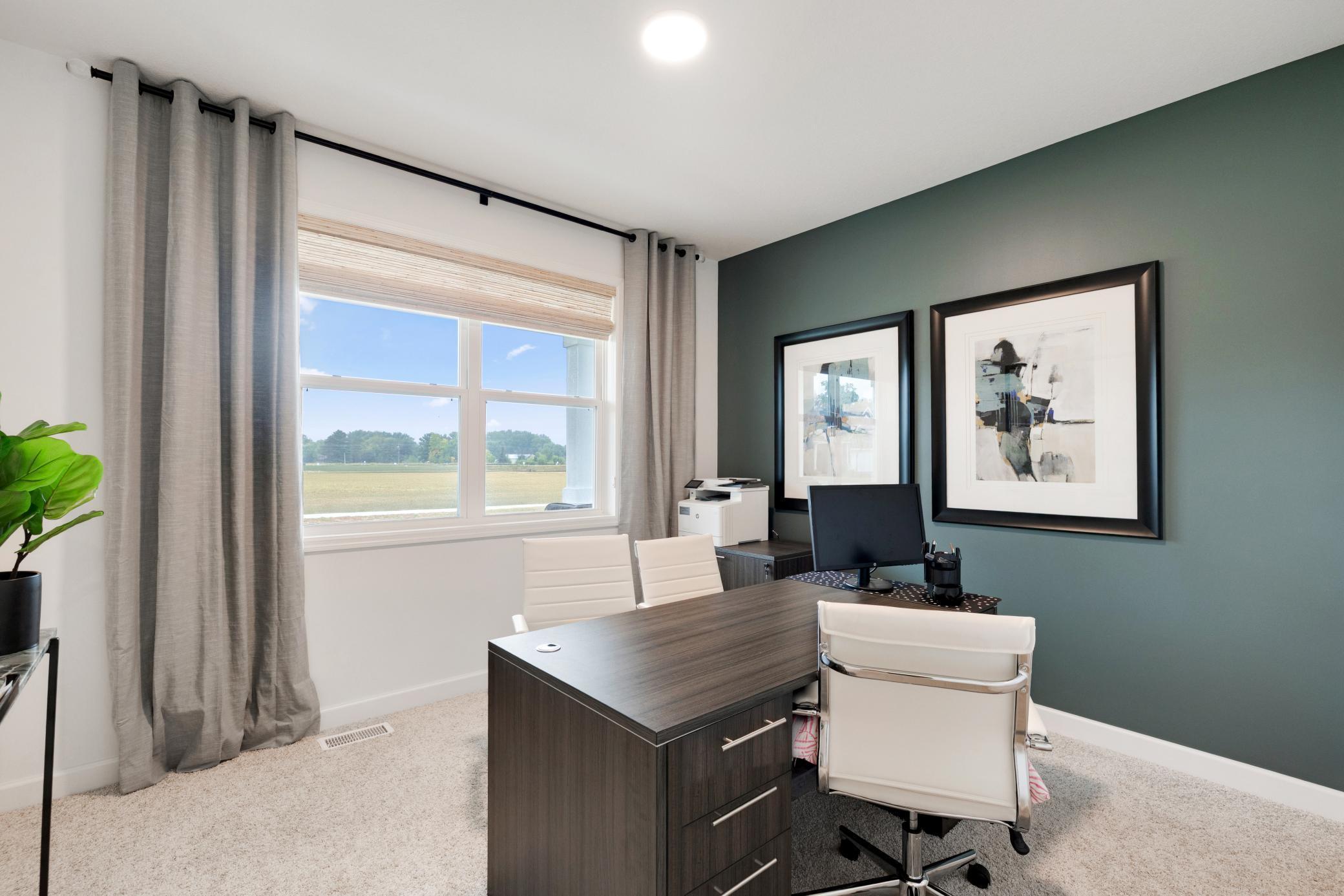 (Photo of a similar home, actual home's finishes will vary slightly) The spacious flex room with French doors.