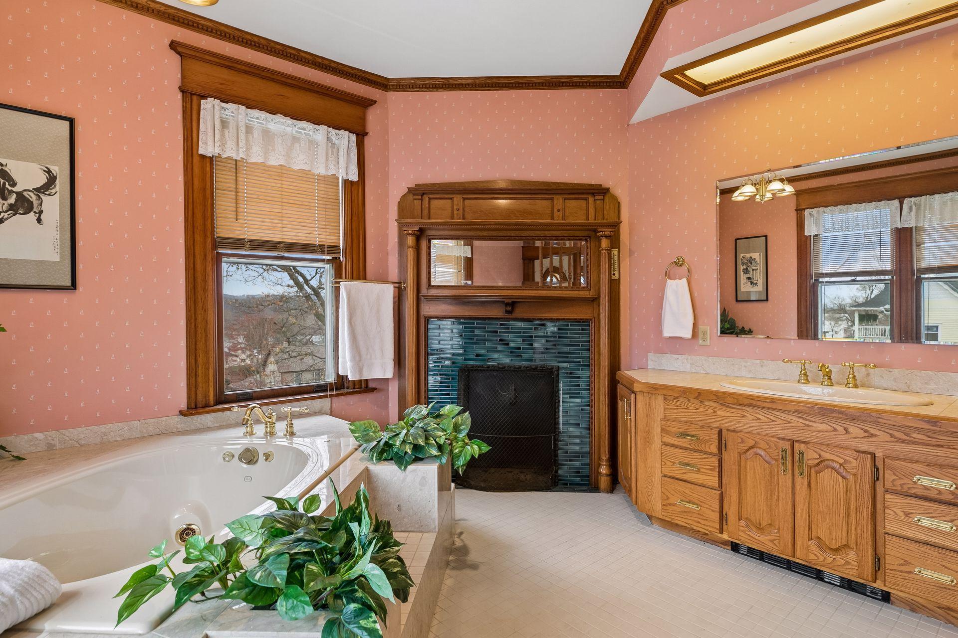Bathroom with jacuzzi tub, separate shower, and wood burning fireplace. Such calming elements of fire and water to create a cozy, intimate sanctuary