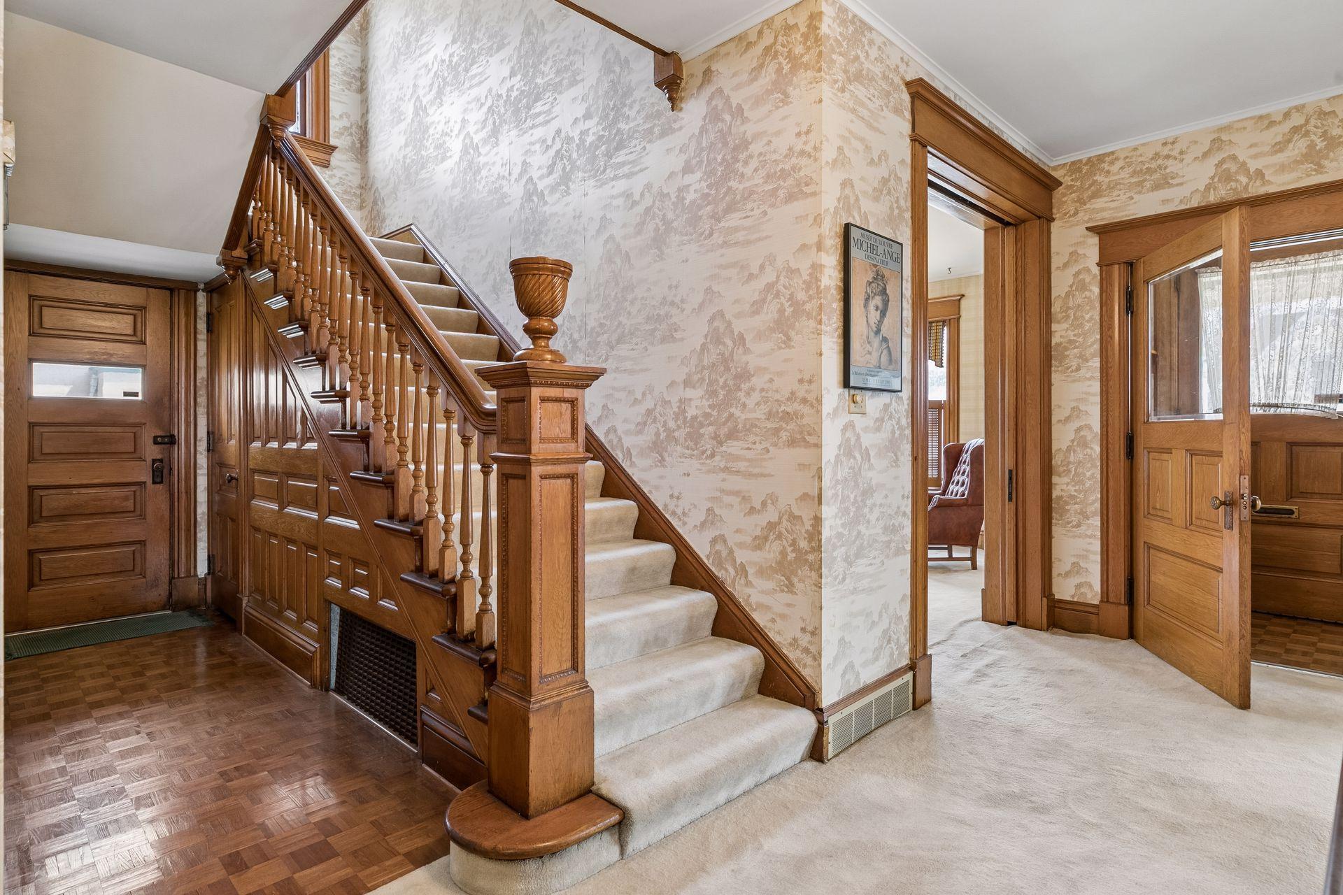 Magnificent staircase and side door entry with closet and parkay flooring