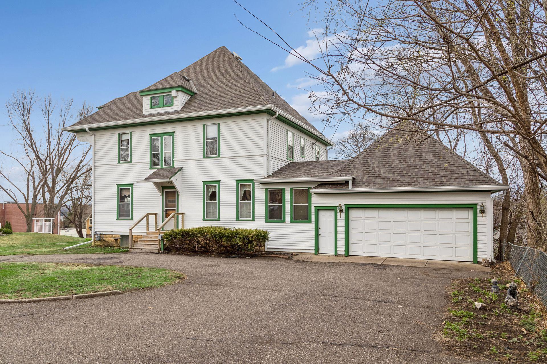 Sideview showcasing circular drive, for plenty of off-street parking. Two-car attached garage