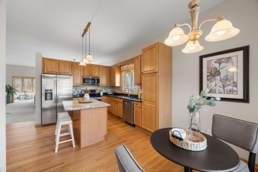 The kitchen is thoughtfully designed with abundant cabinetry, extensive counter space, and a generous center island that’s perfect for meal prep or casual gatherings.