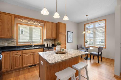 Hardwood floors flow throughout, and the eat-in dinette offers a cozy spot for everyday meals while still feeling connected to the rest of the home.