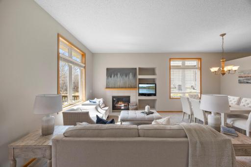 The inviting family room features a warm gas fireplace and opens seamlessly to both the formal dining room and the sunroom.