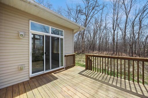 From the sunroom, walk out to the private back deck—an ideal place to enjoy morning coffee, entertain guests, or simply take in the quiet beauty of the surrounding trees.