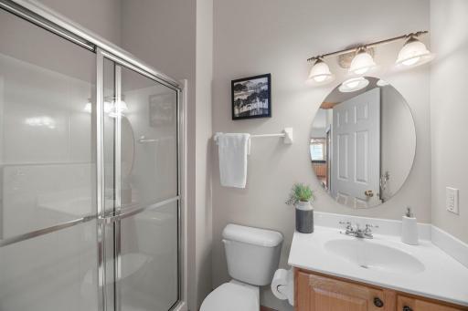 A well-appointed 3/4 bathroom on the main level features modern finishes and everyday convenience.