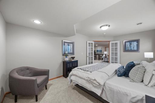 The lower level includes a comfortable additional bedroom ideal for guests or extended living space.