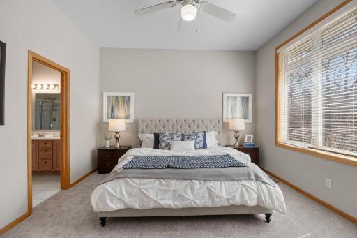 The main-floor primary suite provides a peaceful retreat with oversized windows.