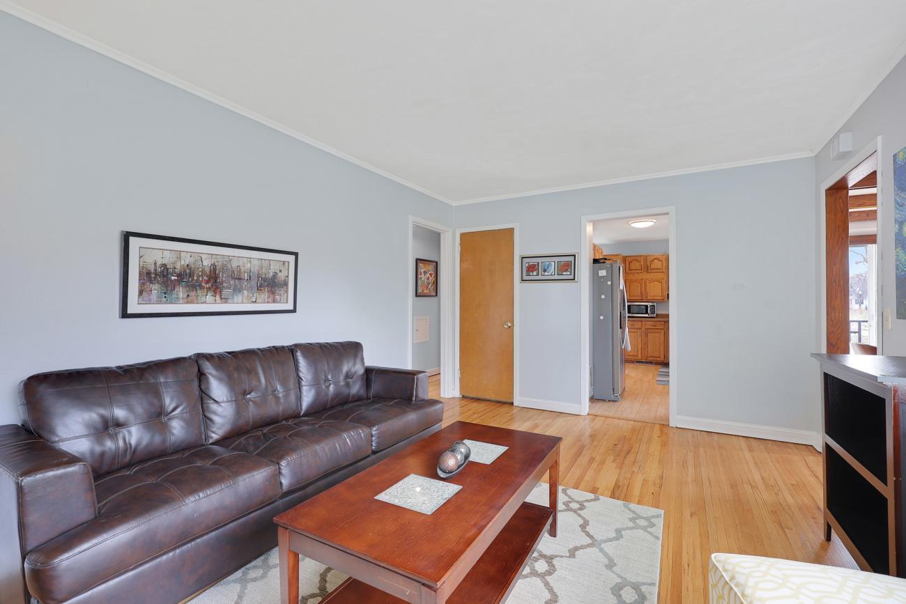 Living room with view of kitchen and door to second floor