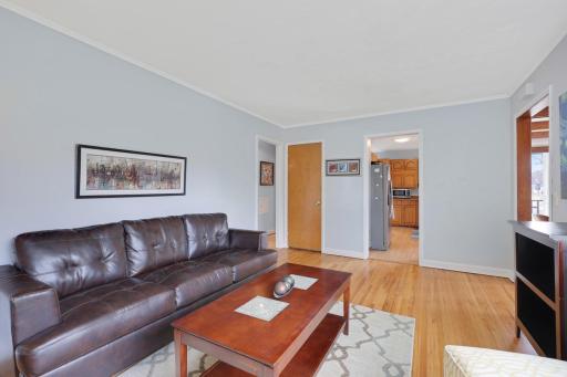 Living room with view of kitchen and door to second floor