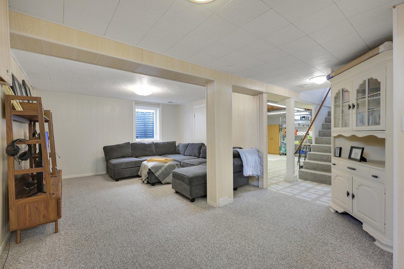 Lower level family room with egress window. Past owner had a wall installed to make this a fourth bedroom