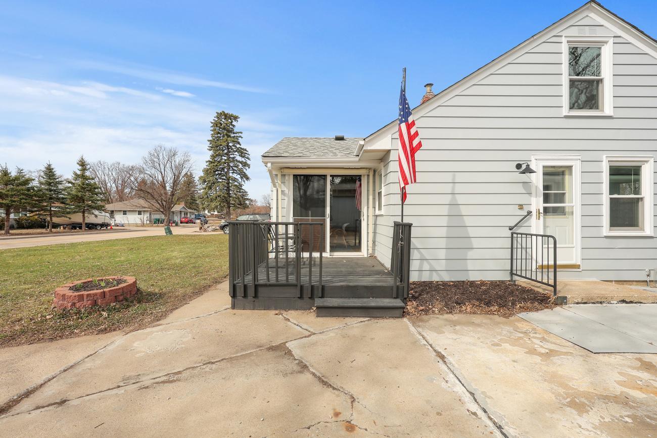 West side of house showing deck and sliding glass door going into dining room, Door on the right side goes to kitchen and basement