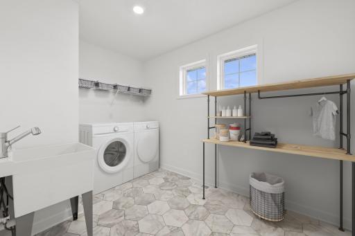 (Photo of a decorated model, actual finishes will vary) Centrally located on the second level, this spacious laundry room provides the ultimate convenience. Note: appliances are not included.