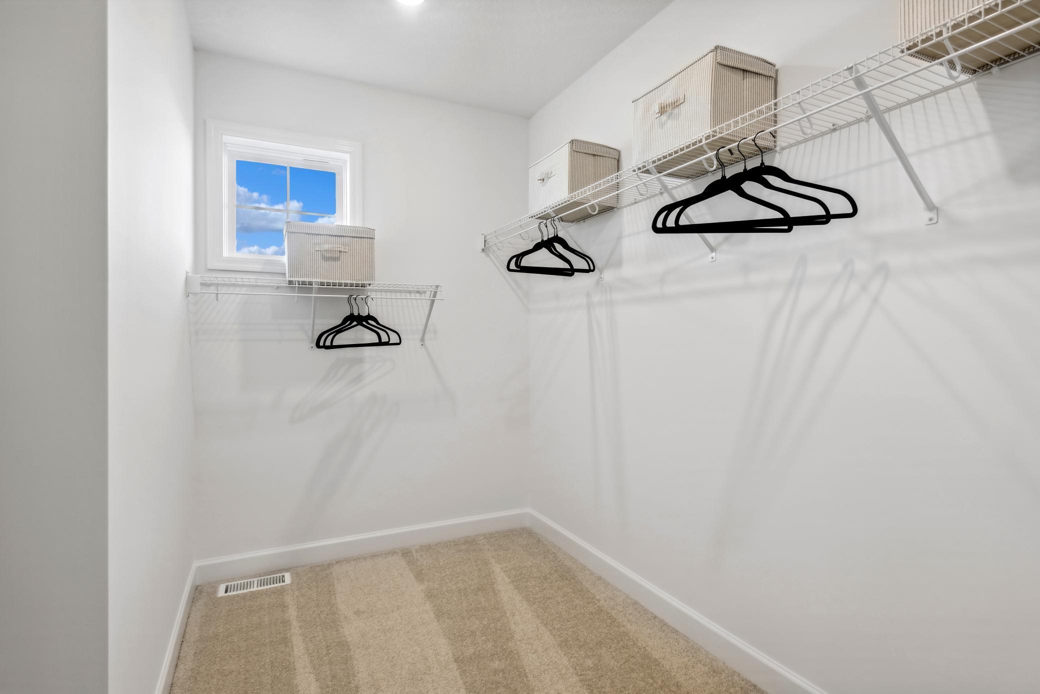 (Photo of decorated model, actual home's finishes will vary) The primary bedroom features an incredible walk-in closet.