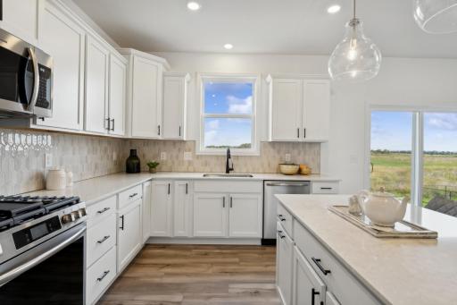 (Photo of a decorated model, actual homes finishes will vary) Another view of the kitchen.