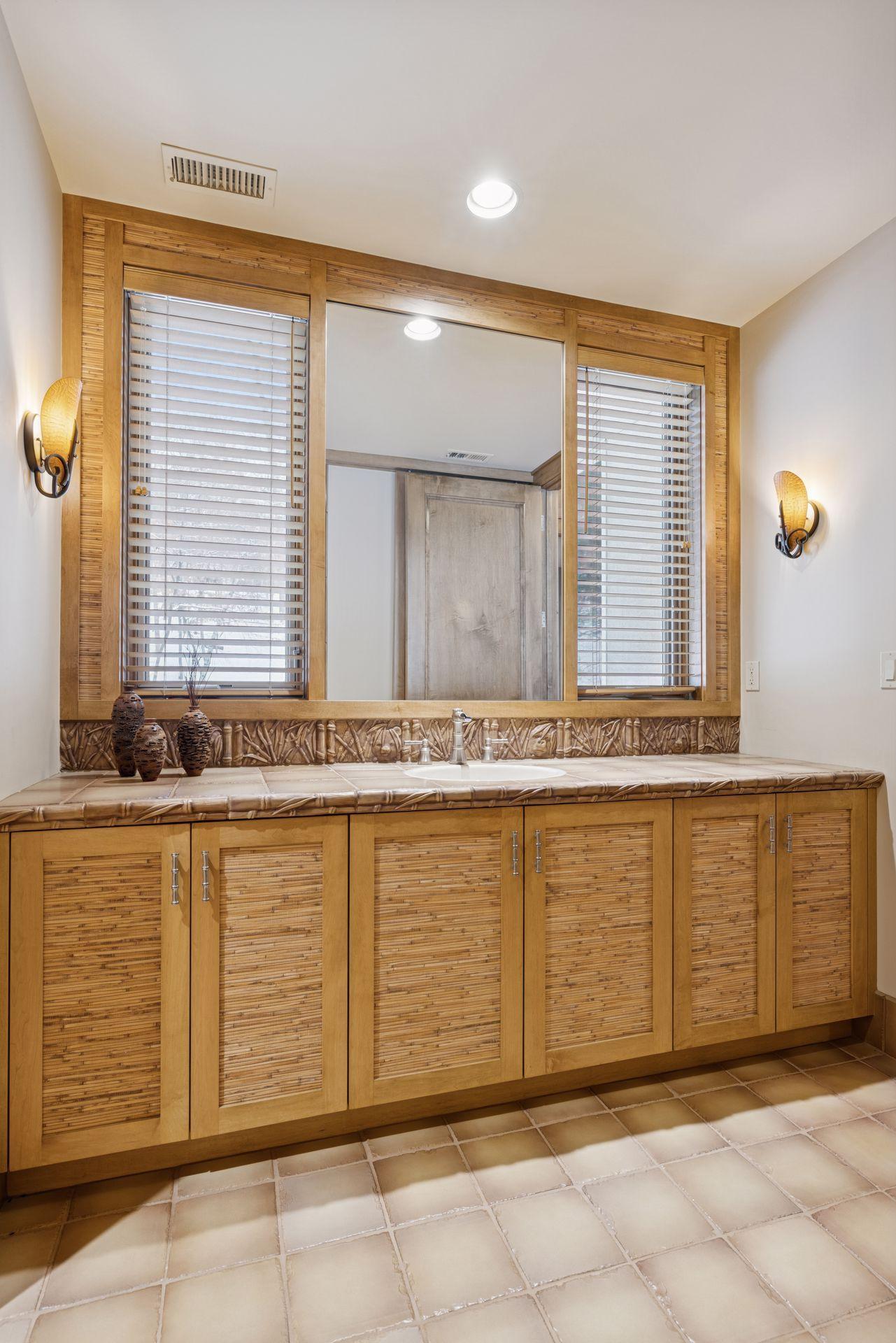 This 3/4 bath sports an oversized walk-in shower and vanity. The tile backsplash fits the safari theme!