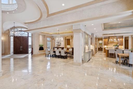 Generous transition space accented with elegant crown molding and recessed lighting, perfectly designed for entertaining groups of any size.