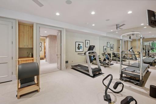 Exercise room with mirrored wall and ballet bar.