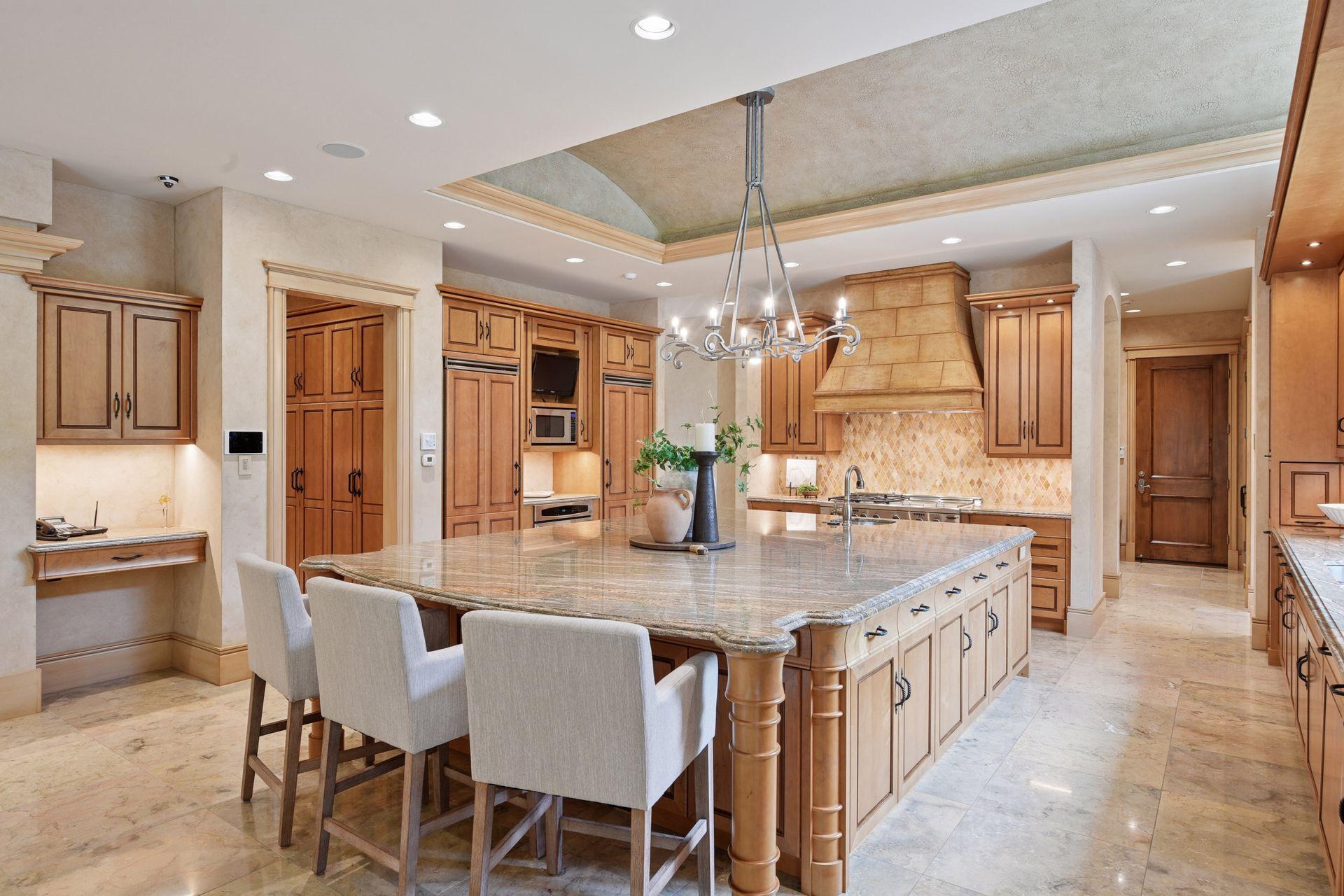 Stunning kitchen featuring a dramatic barrel vault and a grand 21' x 22' center island, with easy access to the Butler’s Pantry just off to the side.