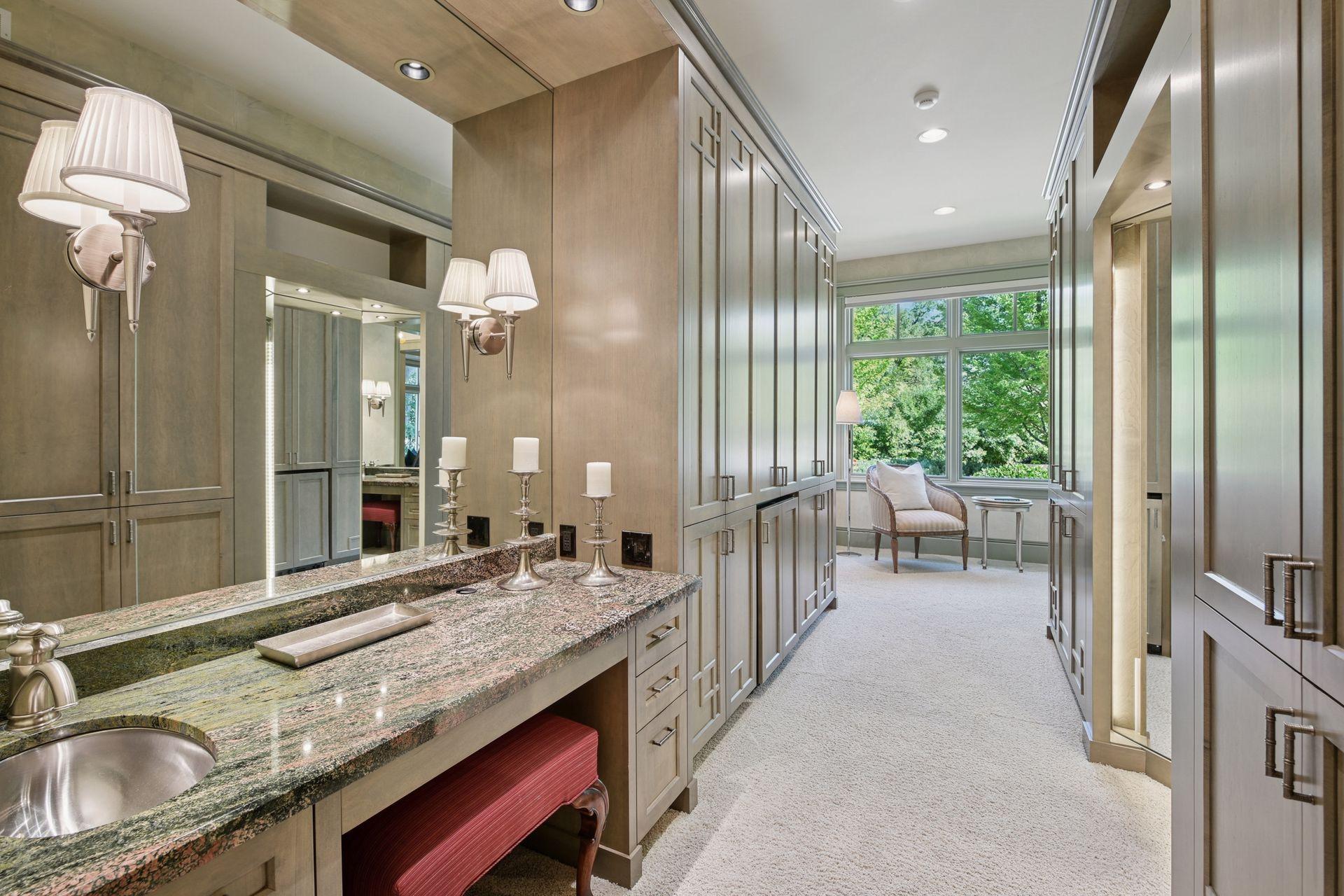 Dressing area featuring a well-lit three-sided mirror.