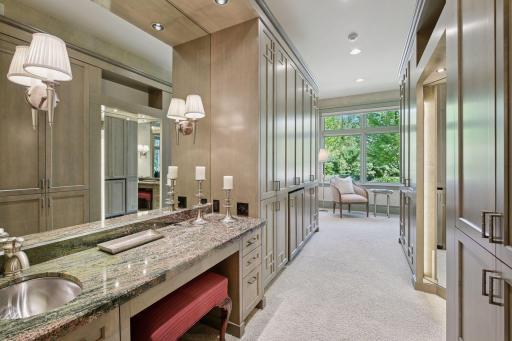 Dressing area featuring a well-lit three-sided mirror.