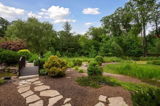 Paver path through the gardens to the waterfall or to a bench on other side of pond.