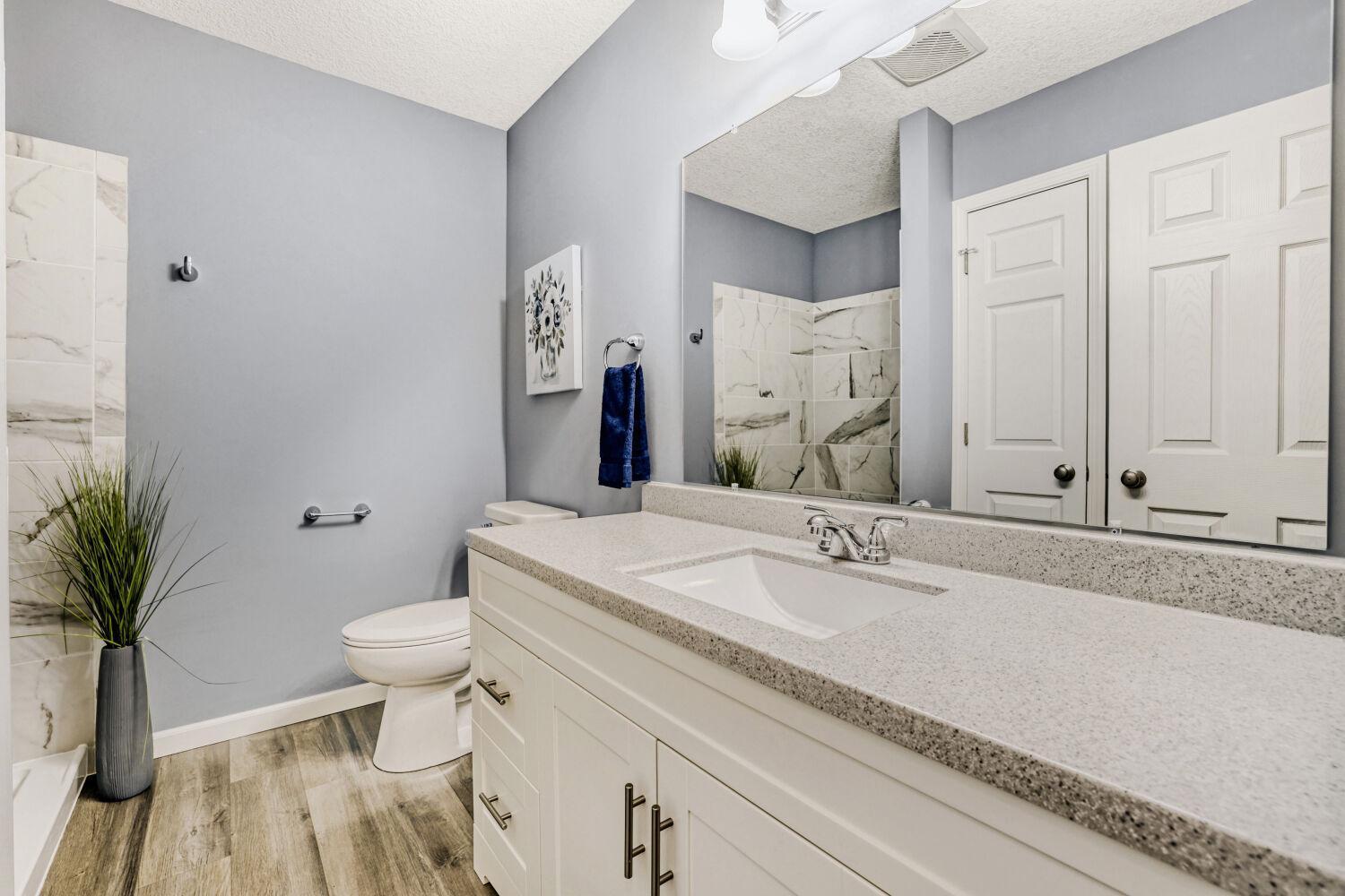 Lower level bath with a tiled shower and 2 closets.