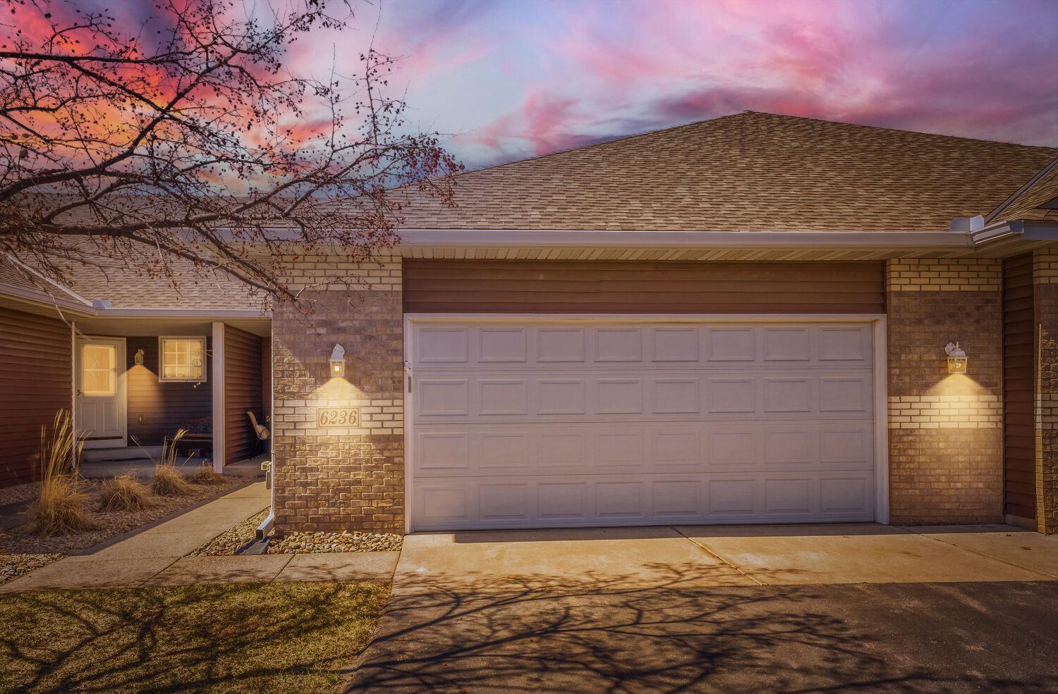 Street view of the garage and sidewalk that lead to the front entrance.