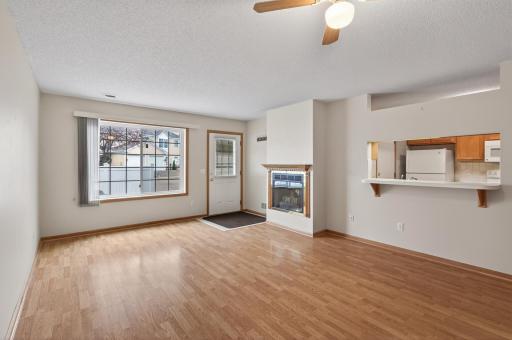 Living Room with gas fireplace and large window. .