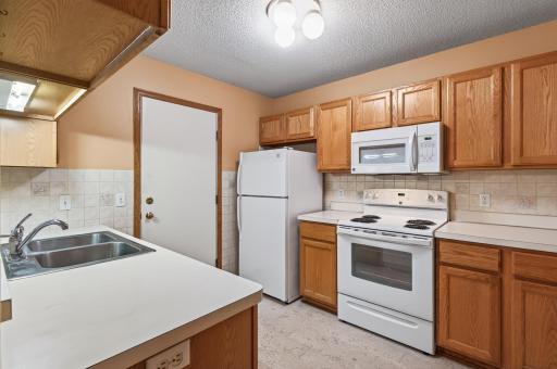 Nice and bright kitchen with matching white appliances.