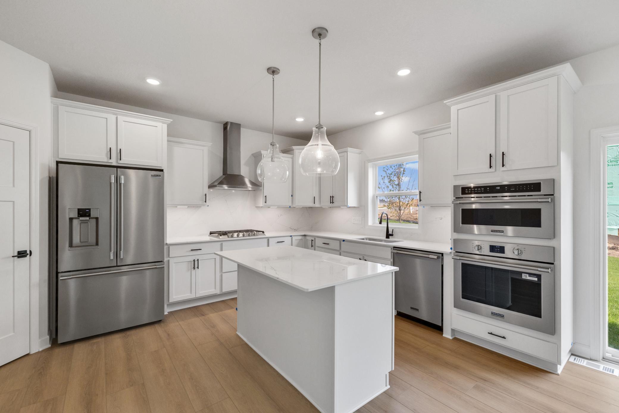 (Photo of a decorated model, actual homes finishes will vary) The gourmet kitchen.