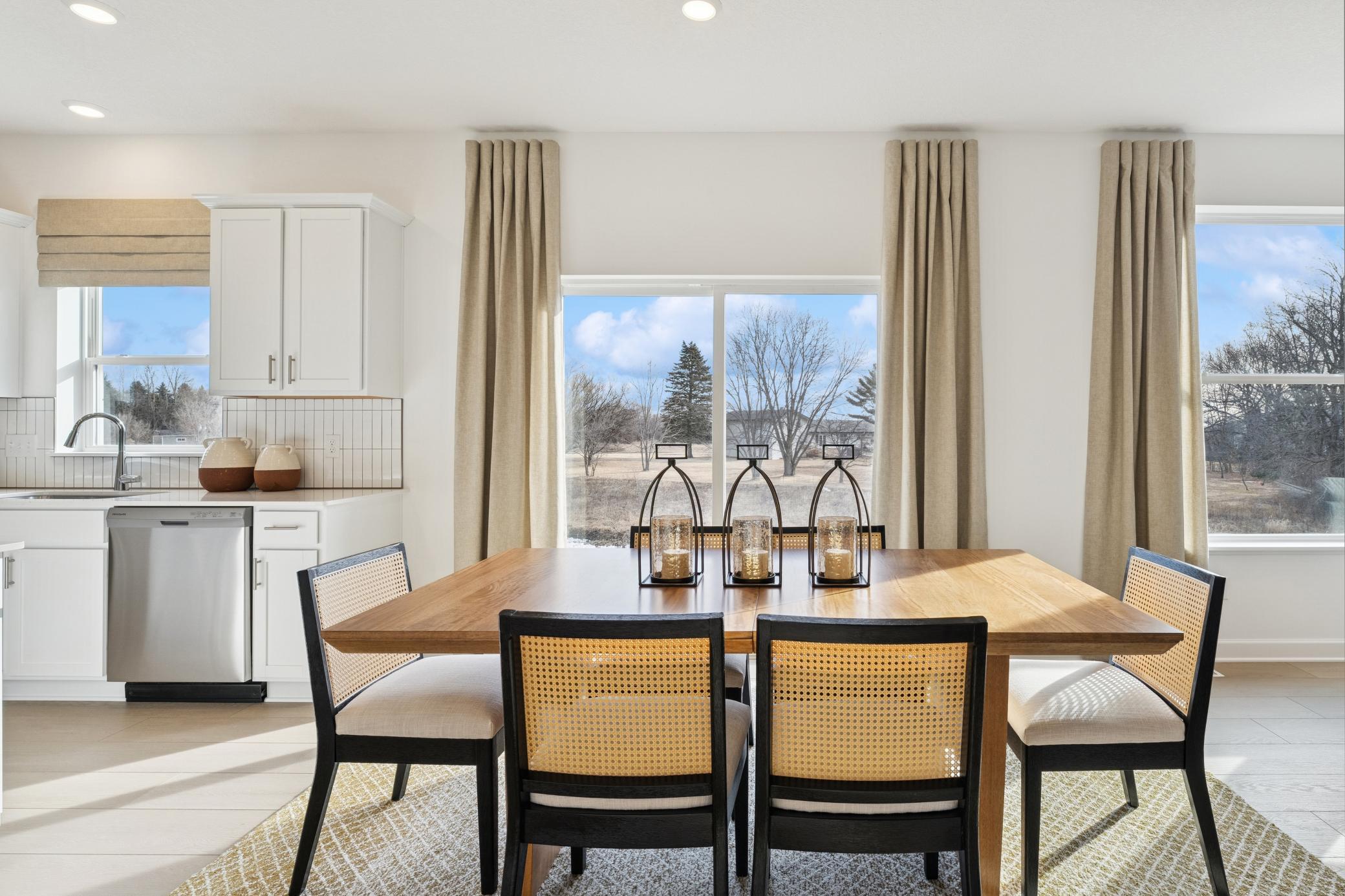 (Photo of a decorated model, actual homes finishes will vary) Located in the heart of the home, the eat-in dining room has ample space for a dining table located in the heart of the home.