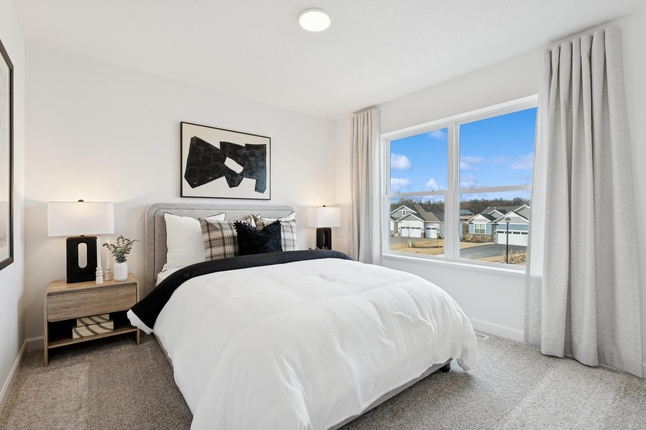 (Photo of a decorated model, actual homes finishes will vary) One of the secondary bedrooms that comes perfectly sized with a spacious closet.