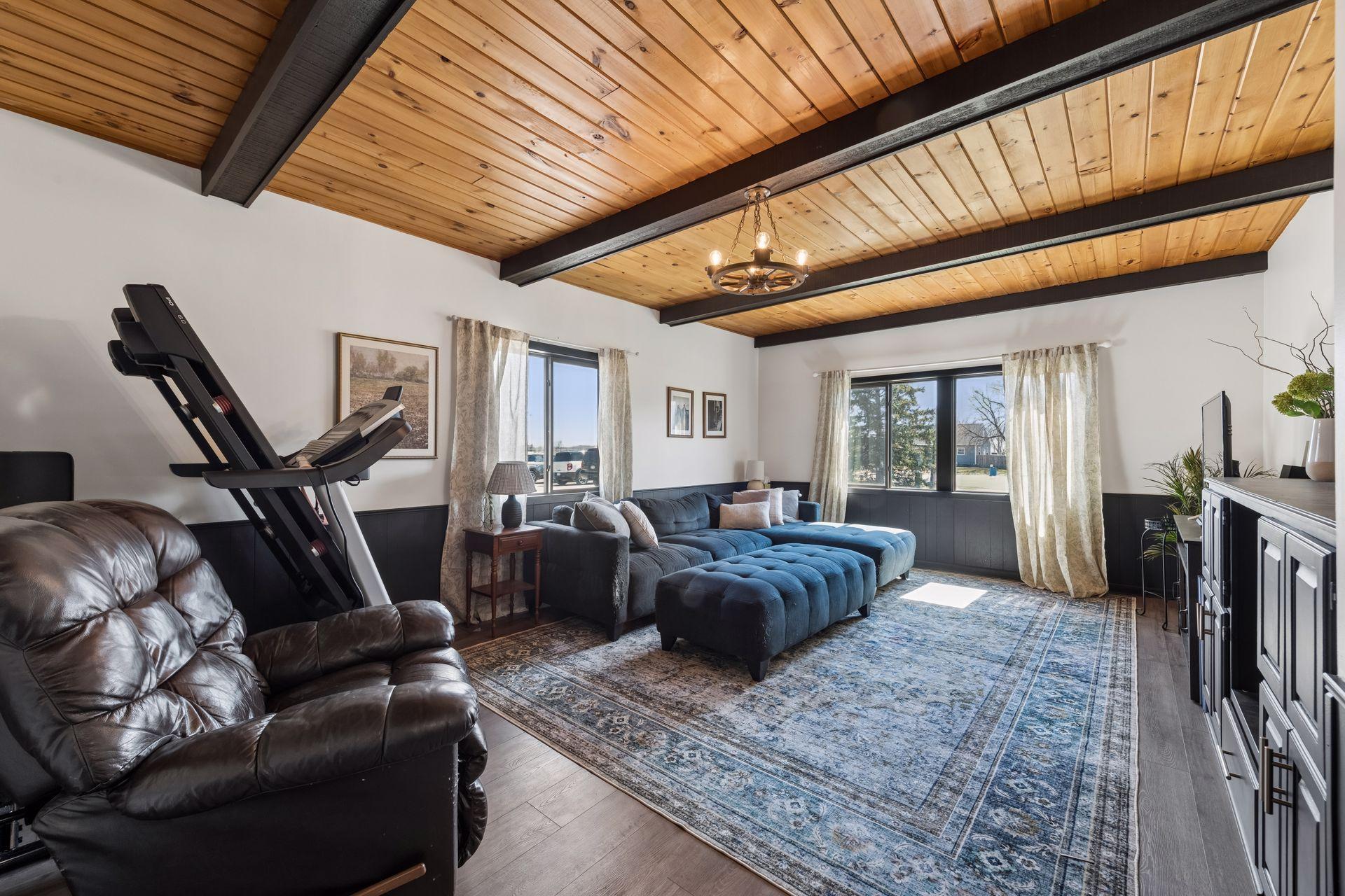 Main floor family room has vinyl plank flooring, painted wainscoting & beautiful wood ceiling - 0029.jpg