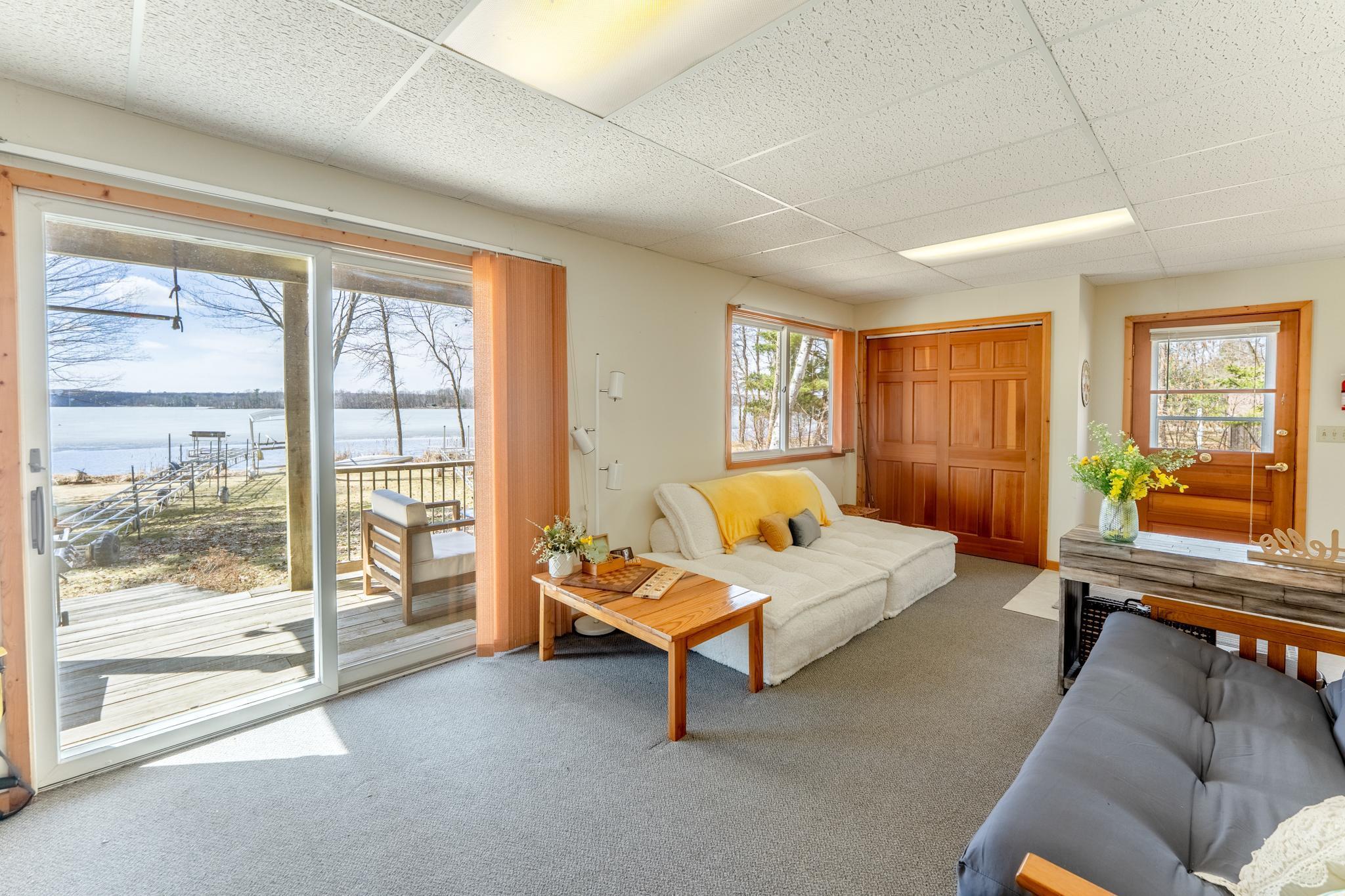 The flex space leads out to the lower, covered deck and right down to the lake.