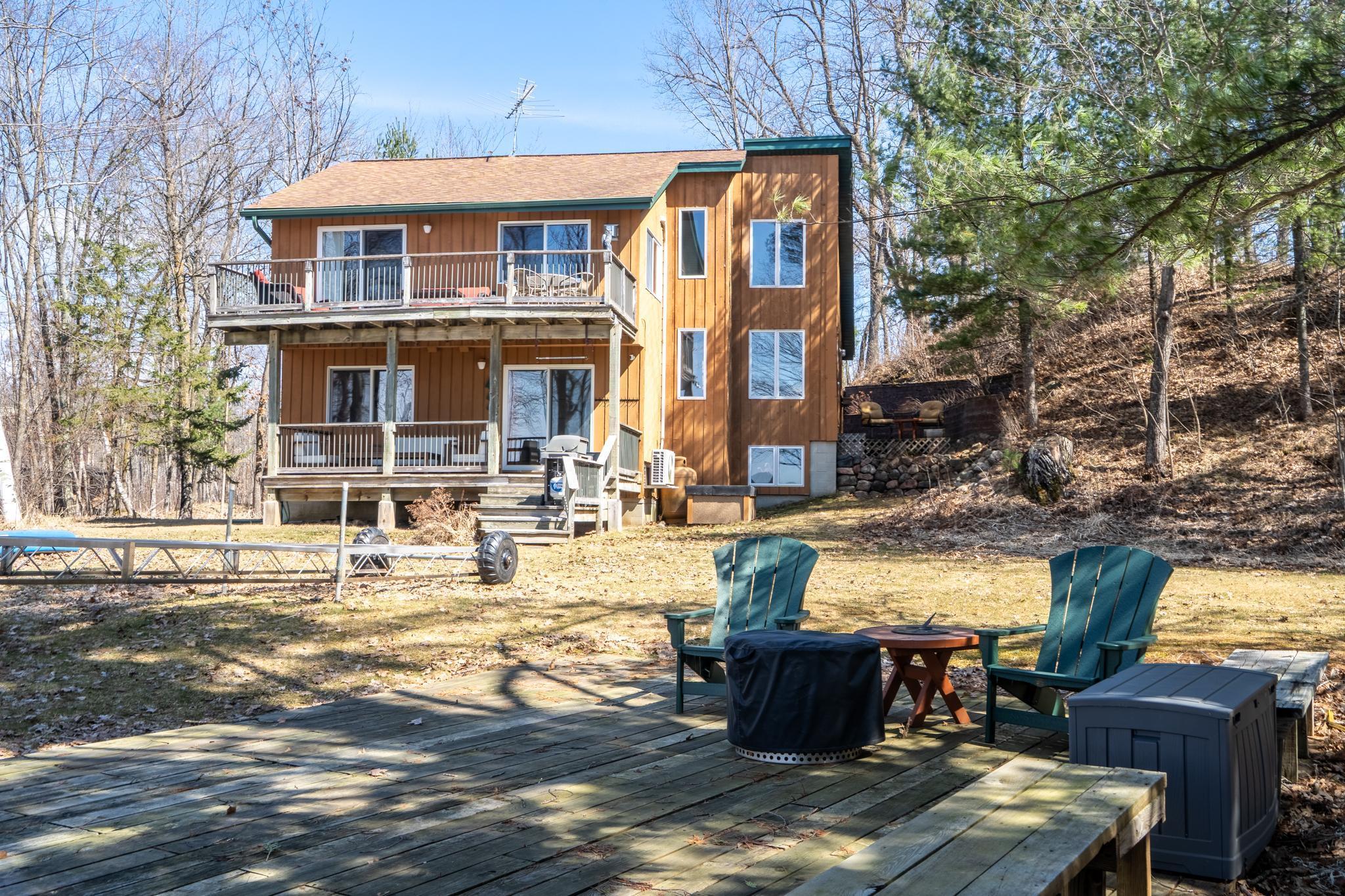 Okay not time yet to put the dock in, but here's the view of the large, flat lot and deck for lakeside hanging out (located on the site of the original cabin in 1964!).