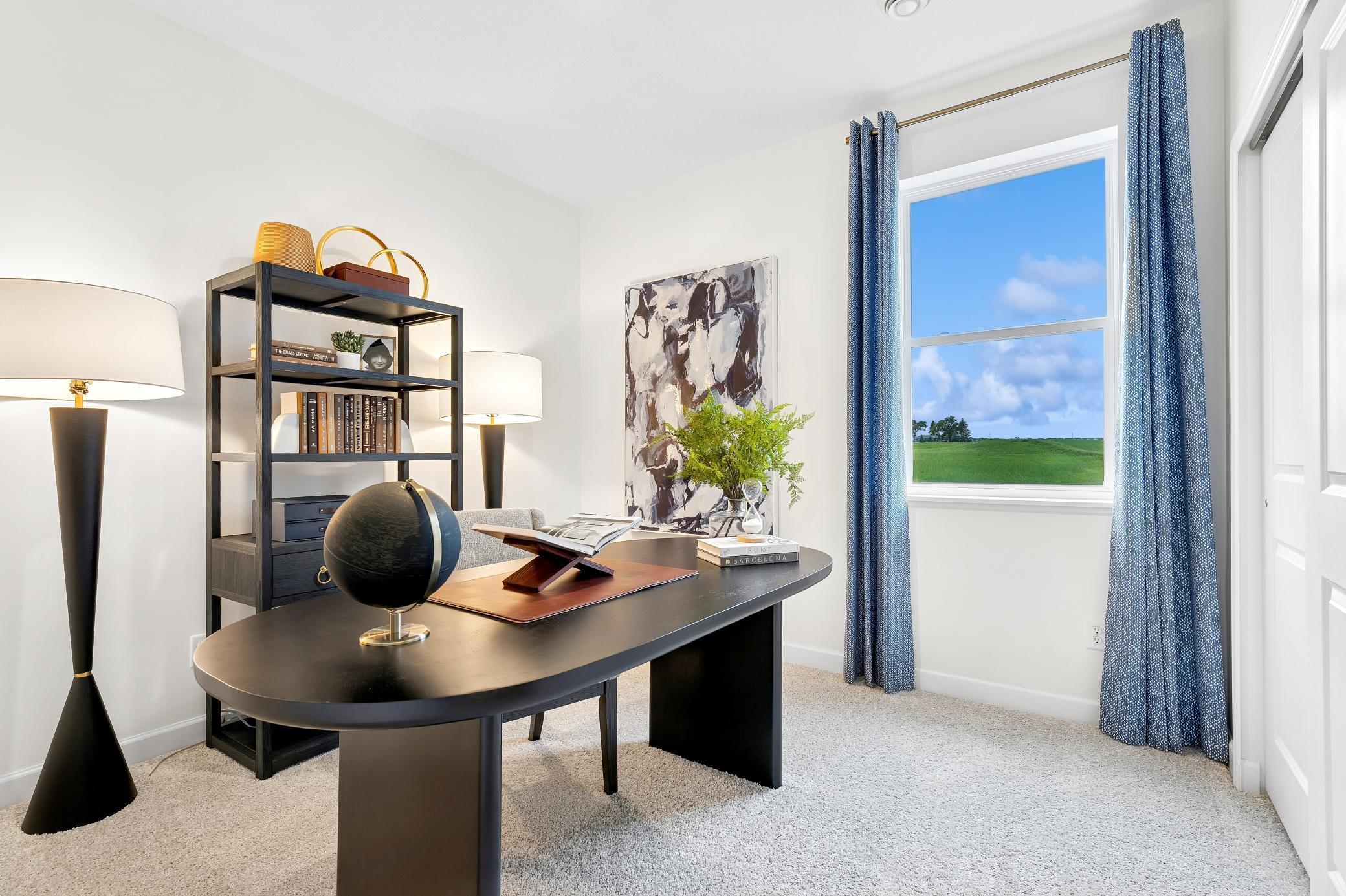 (Photo of a decorated model, actual homes finishes will vary) The main floor bedroom.