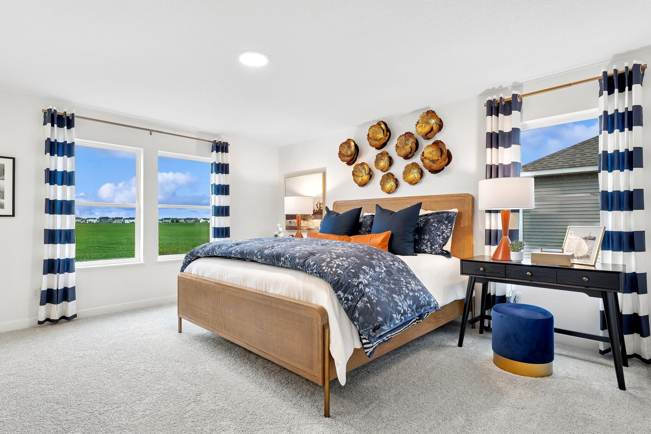 (Photo of a decorated model, actual homes finishes will vary) The second-floor primary suite is a private sanctuary within the home, complete with a spa-like bathroom and a generous walk-in closet.