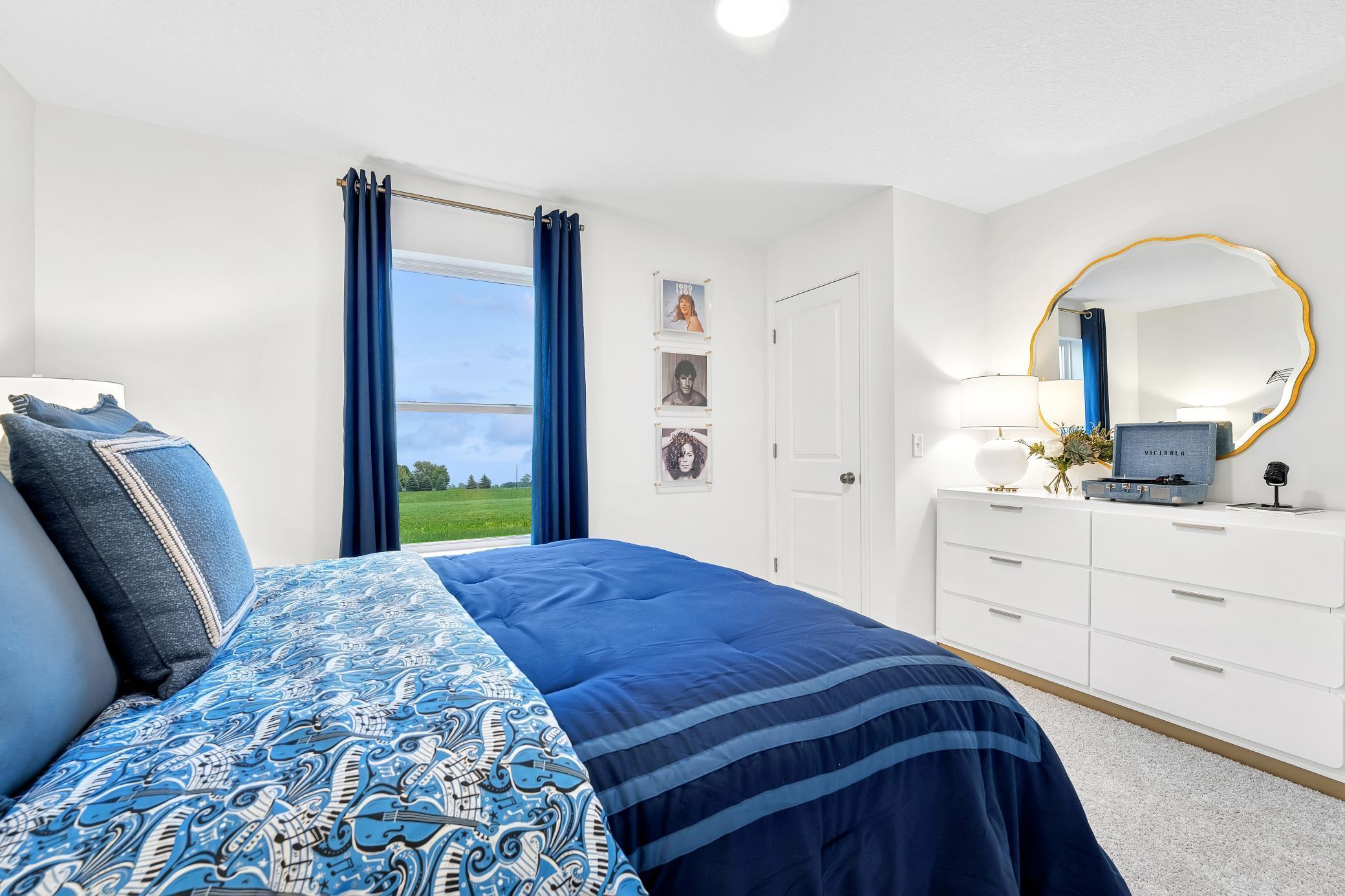 (Photo of a decorated model, actual homes finishes will vary) Three secondary bedrooms are found upstairs, just down the hall from the loft and the primary suite.