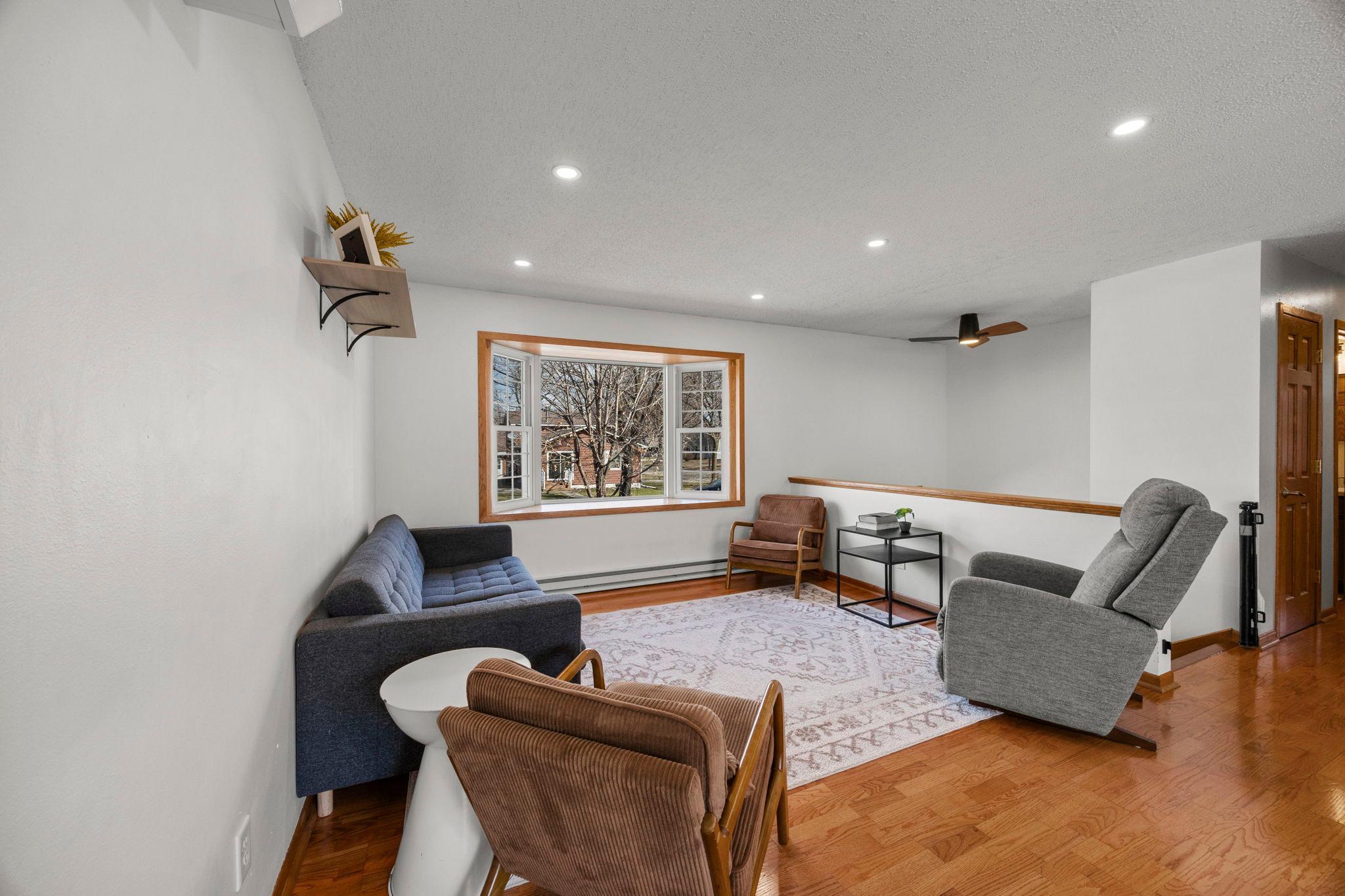 The living room features a large bay window that brings in tons of light, perfect for a reading nook or a relaxing spot to unwind.