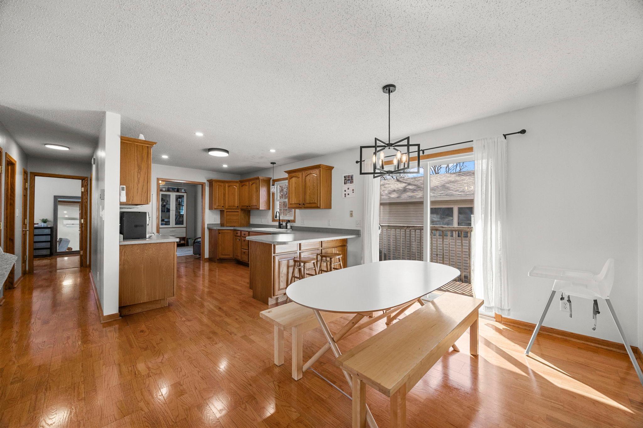 The dining area sits just off the kitchen with sliding glass doors leading out to the back deck for easy indoor-outdoor living.