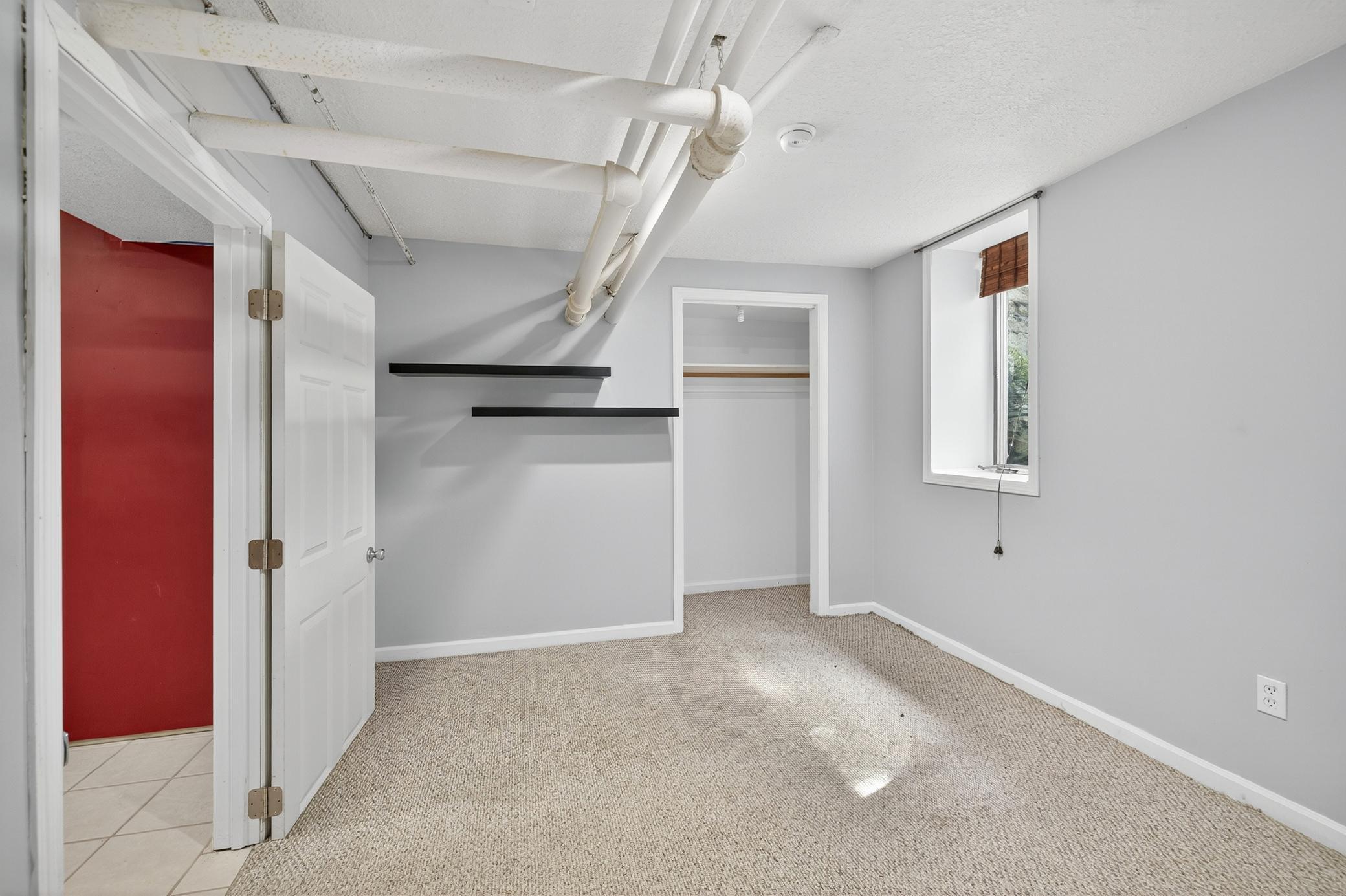 Lower level bedroom with egress window