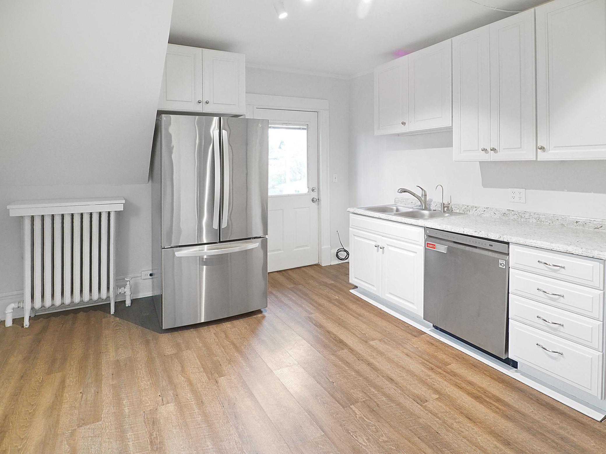 Upper unit kitchen with vinyl flooring
