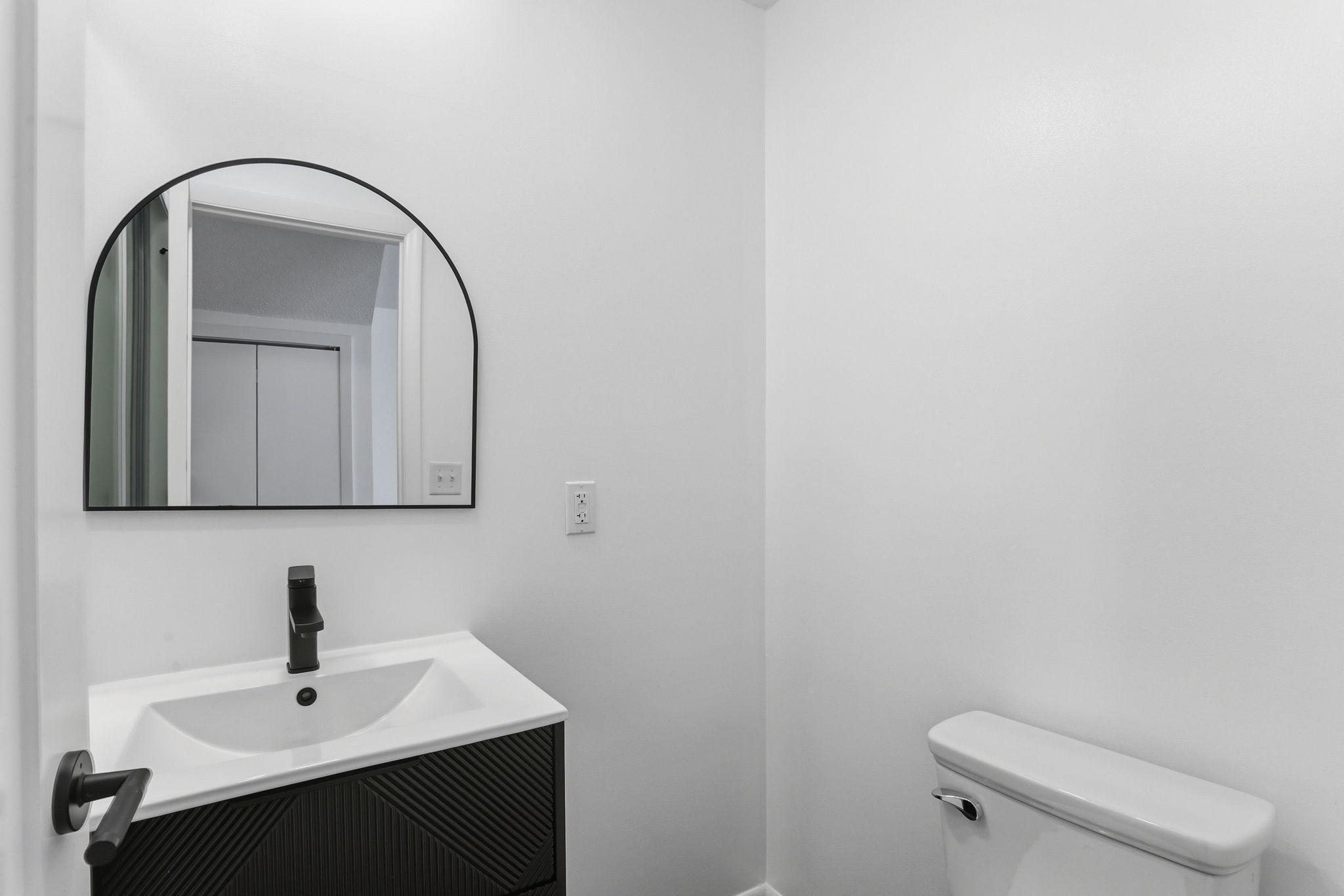 Beautifully updated main floor half bath featuring a clean, modern design