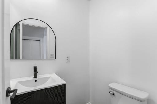 Beautifully updated main floor half bath featuring a clean, modern design