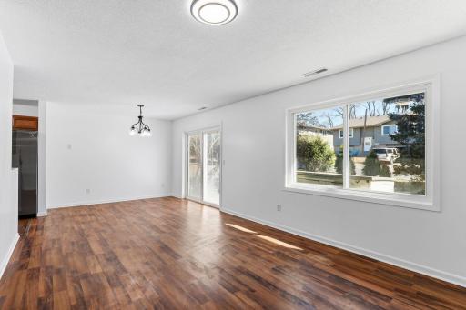 Open-concept main floor seamlessly connects the living room and dining area, creating a bright and inviting space perfect for everyday living and entertaining