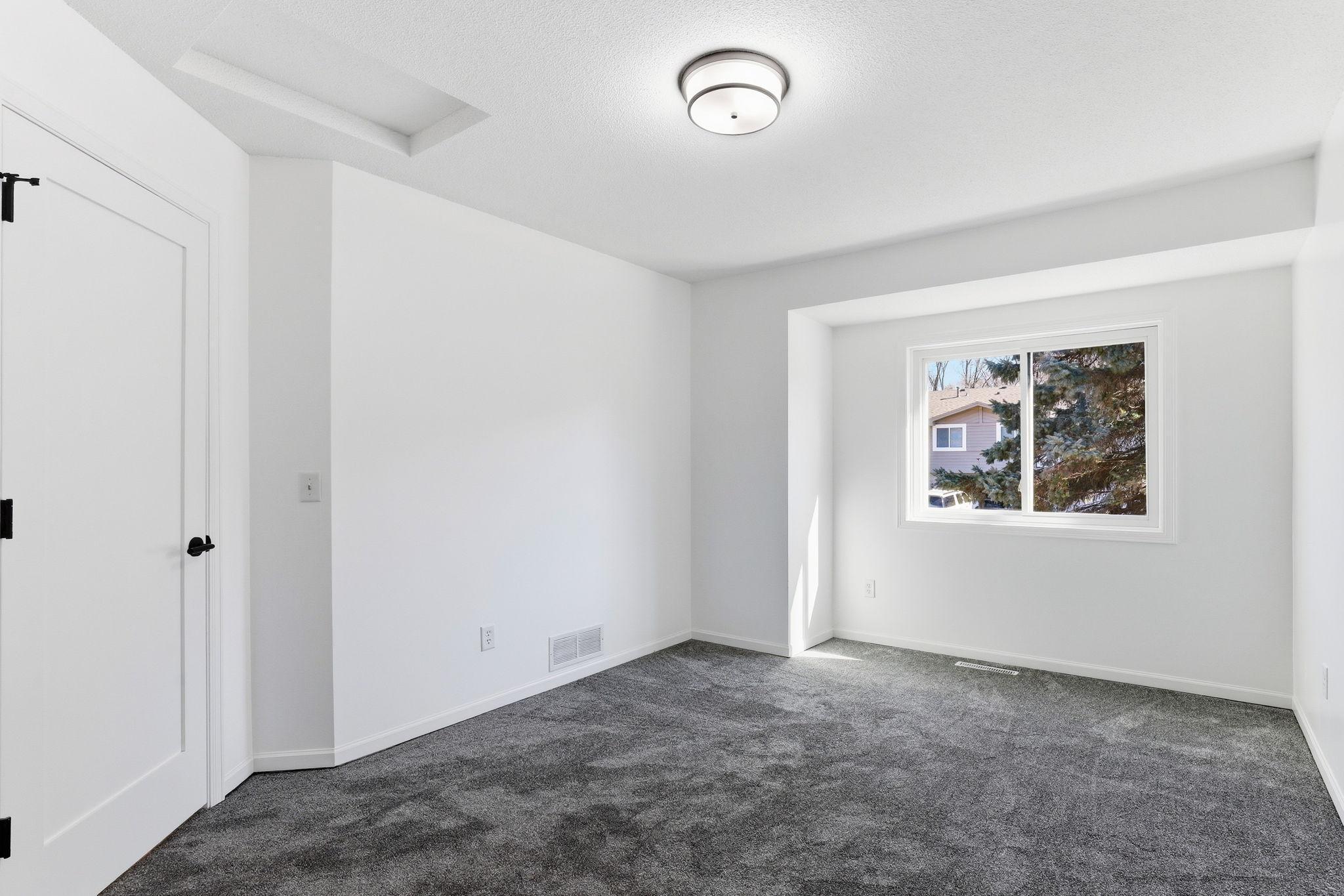 Comfortable second bedroom perfect for guests, a home office, or additional living space