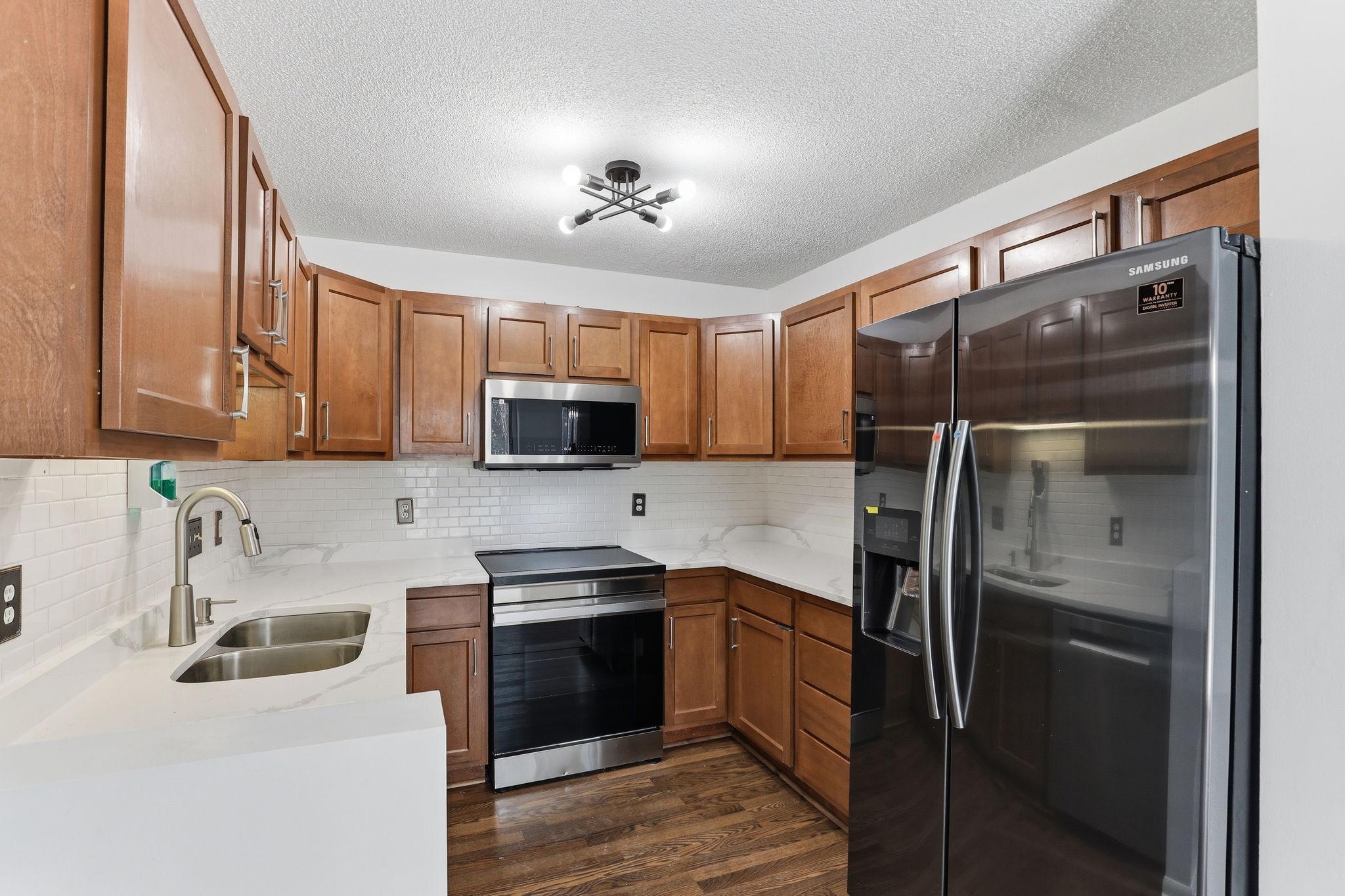 Beautifully updated kitchen with new granite countertops and stainless steel appliances
